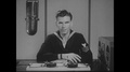Pond5 1940s: man sits at desk with radio equipment, talks. man flips switch on