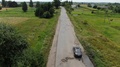 Aerial View Of Cars On An Old Road With Potholes Near Farmland