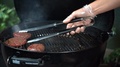 Chef In Gloves Checking With Spatula Beef Burgers On Barbecue Grill