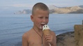 Pond5 Child on the beach eats ice cream from a waffle cone