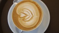 Close Up Of Hot Coffee Latte In White Cup On Table