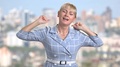 Middle-Aged Woman Is Yawning On Blurred Background.