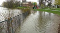 Water From River Overflowing Onto Yard And Playground In Canada